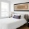 a bedroom with a bed and lamps