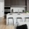 a kitchen with a white table and chairs